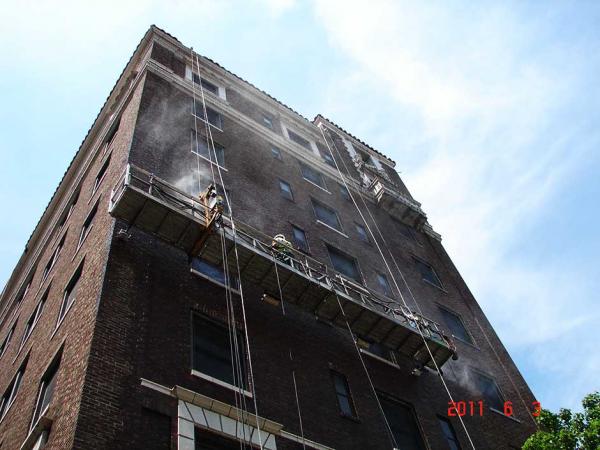 Crew Cleaning Brick Building