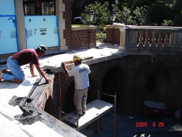 Crew Members Repairing Stone