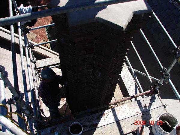 Crew Member Repairing a Chimney