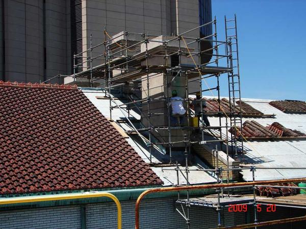 Crew Members Repointing a Commercial Building