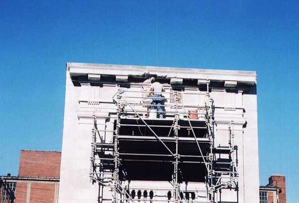 Crew Member Repairing Stone Building